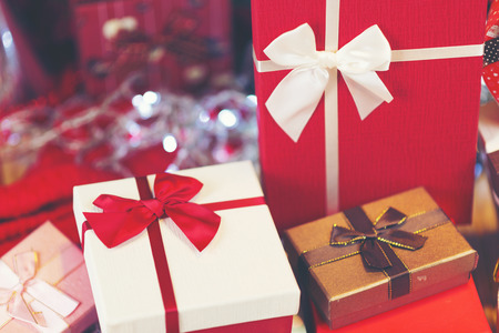 Christmas background with decorations and gift boxes on wooden board