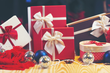 Christmas background with decorations and gift boxes on wooden boardの写真素材