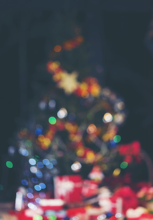 Christmas home room with tree and festive bokeh lighting, blurred holiday backgroundの写真素材