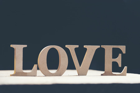 Wooden letters forming word LOVE written on wooden backgroundの写真素材