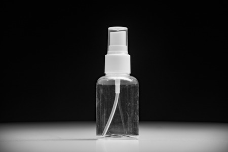 Empty cosmetic bottle container isolated on black backgroundの写真素材