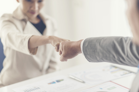 business people join hand while meeting in officeの写真素材