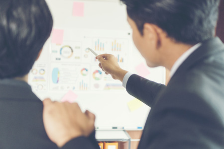business couple working together on project at modern startup officeの写真素材