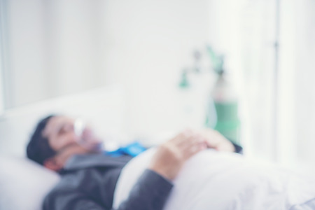 abstract blurry background of Businessman are sick, Working on Hospital Bed, Work Hard Conceptの写真素材