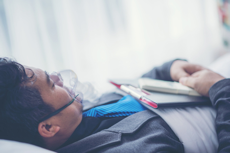 Businessman are sick, Working on Hospital Bed, Work Hard Conceptの写真素材
