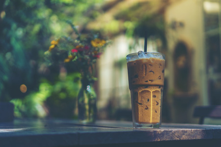 ice coffee glass on wooden table in the cafeの写真素材