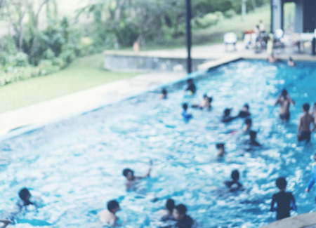 abstract blurry background of people in swimming poolの写真素材