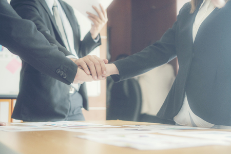 Dramatic moment.Split tone instragram like process.With hot light. People Hand Assemble Corporate Meeting Teamwork Conceptの写真素材