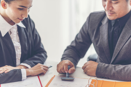 Business stamping rubber Stamp on a documents - business conceptの写真素材