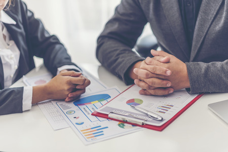 Image of business partners discussing documents and ideas at meeting
