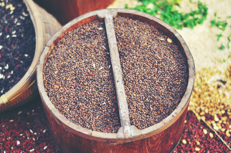 seeds of mustard, flax, coriander and sunflower are spilled from linen sacsの写真素材