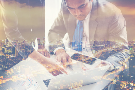 Double Exposure of a business teamwork concept with city night backgroundの写真素材
