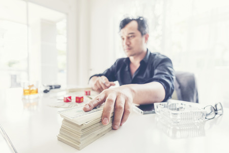 Hand receiving money, US dollar (USD) bills, from businessman hand - vintage style color effectの写真素材