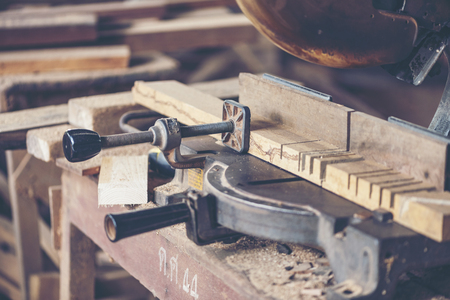 Background image of woodworking workshop: carpenters work table with different tools and wood...