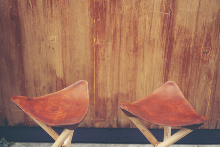 Three-legged camping chair, Made of wood and leather.の写真素材