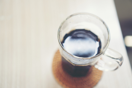 black hot coffee on table in the cafeの写真素材