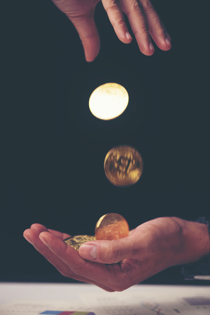 making money with bitcoin - Business man creating bitcoins with his handの写真素材