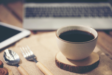 Laptop computer, phone and coffee in the garden - freelance or remote work conceptの写真素材