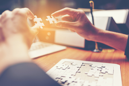 business success concept using jigsaw puzzle, vintage filter imageの写真素材