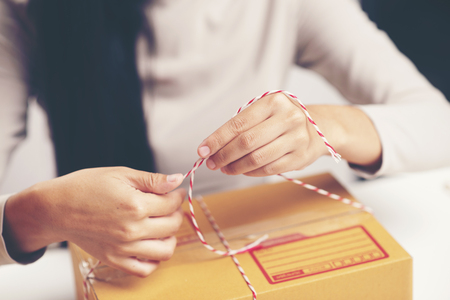 Female hands packing box at warehouse, online marketing conceptの写真素材