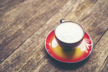coffee latte art in red cup, vintage filter imageの写真素材