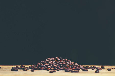 coffee beans on wooden background, arabica coffee, vintage filter imageの写真素材