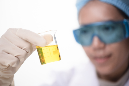 Conical flask in scientist hand with lab glassware background, Laboratory research conceptの写真素材