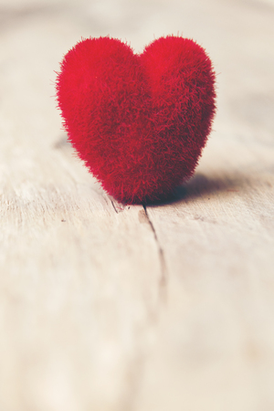 Valentines day red heart on old wood. Holidays card with copy spaceの写真素材