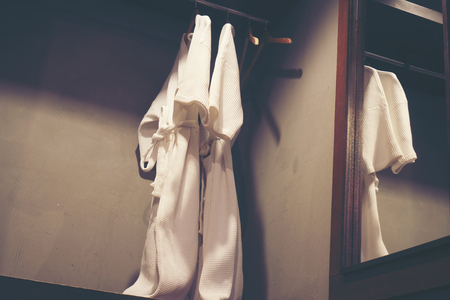 Bathrobe hanging on wallの写真素材