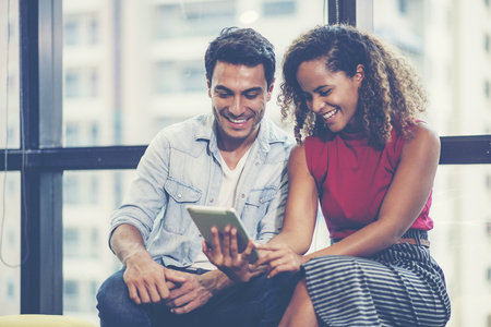 Businesswoman and businessman looking at tablet togetherの写真素材