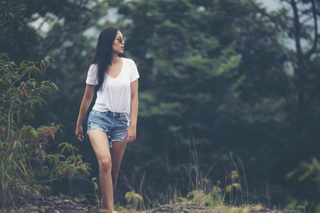 alone asian girl walking in the forestの写真素材
