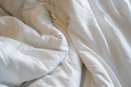 Bed linen that is crumpledの写真素材