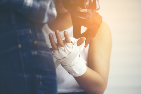 young boxer wrapping hands with boxing wrapsの写真素材