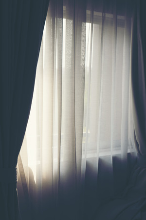White curtains in a warm bedroomの写真素材