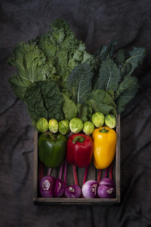 Healthy food clean eating selection in wooden box: fruit, vegetable, seeds, superfood, cereals, leaf vegetable on gray backgroundの写真素材