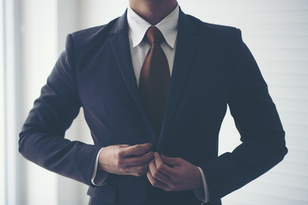 Businessmen are tying necktie. To prepare for the presentationの写真素材