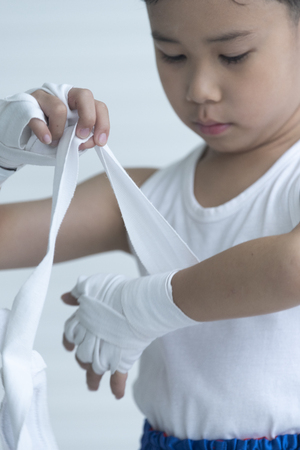 The boy boxer is wrapped in his hands.の写真素材