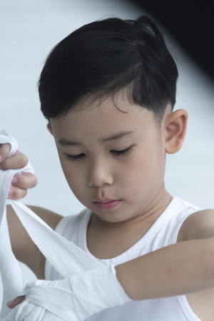 The boy boxer is wrapped in his hands.の写真素材