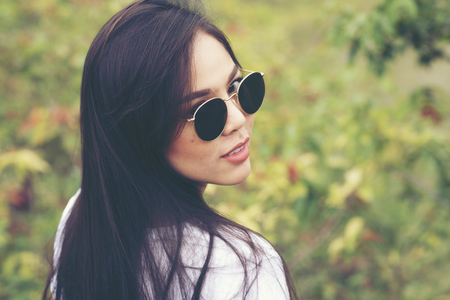 portrait girl on outdoors with sunglassesの写真素材