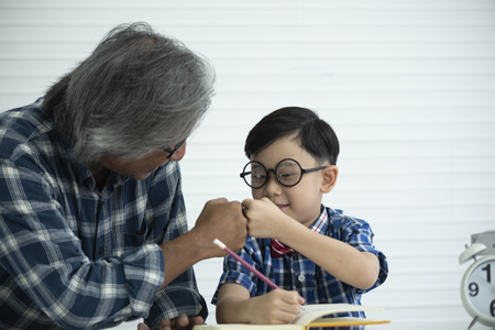 Older teachers are teaching students to do homework, education conceptの写真素材