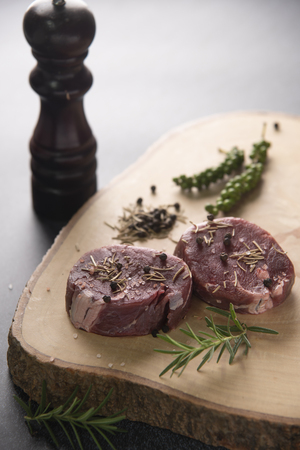 Fresh raw Prime Black Angus beef steaks on wooden board: Tenderloin, Denver Cut, Striploin, Rib Eyeの写真素材