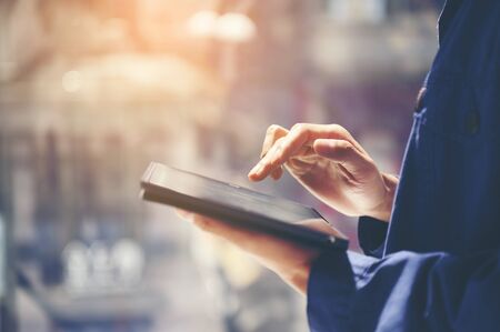 Male Architect With Digital Tablet Studying Plans In Officeの写真素材