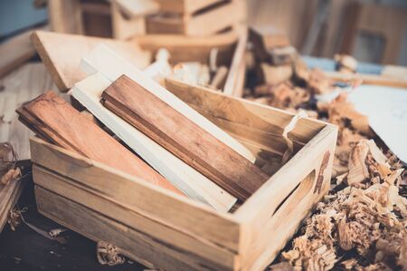 Background image of woodworking workshop, carpenters work table with different tools and wood cutting stand, vintage filter imageの写真素材