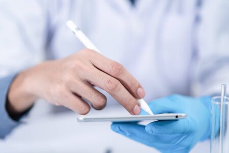 Scientists are working with digital tablet in laboratoryの写真素材