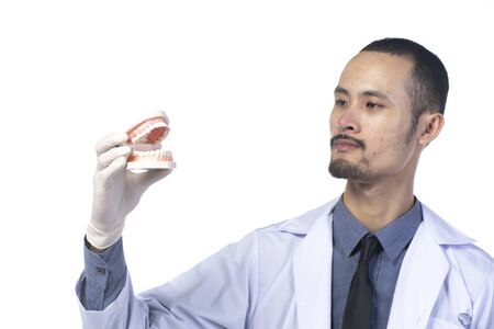 dentist with Dental tools isolated on white backgroundの写真素材