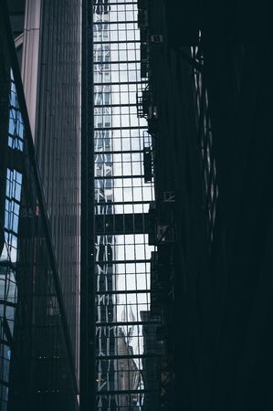 Panoramic and perspective wide angle view to steel blue background of glass high rise building...