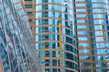 Panoramic and perspective wide angle view to steel blue background of glass high rise building...