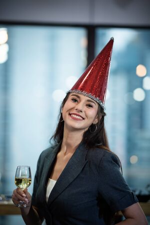 A group of business people holding a glass of champagne in a party to celebrate their successの写真素材
