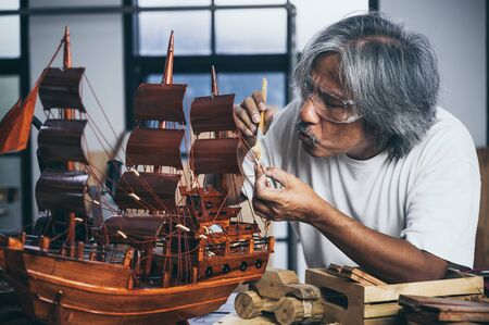 Carpenter working on woodworking machines in carpentry shop. woman works in a carpentry shop.の写真素材