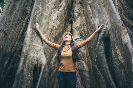 Asian women interact with trees. Natural touchの写真素材